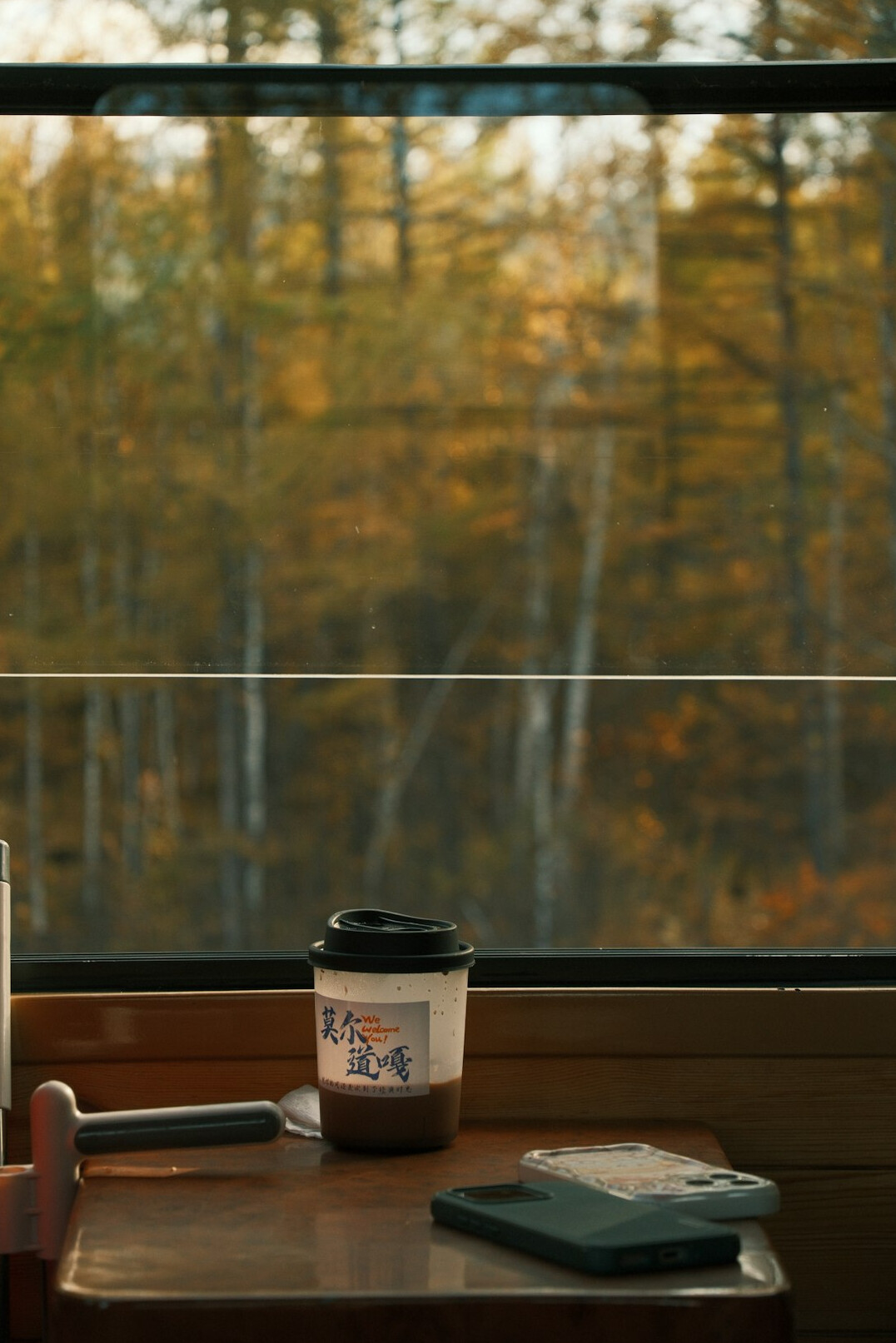 Wooden desk with laptop notebook and coffee cup